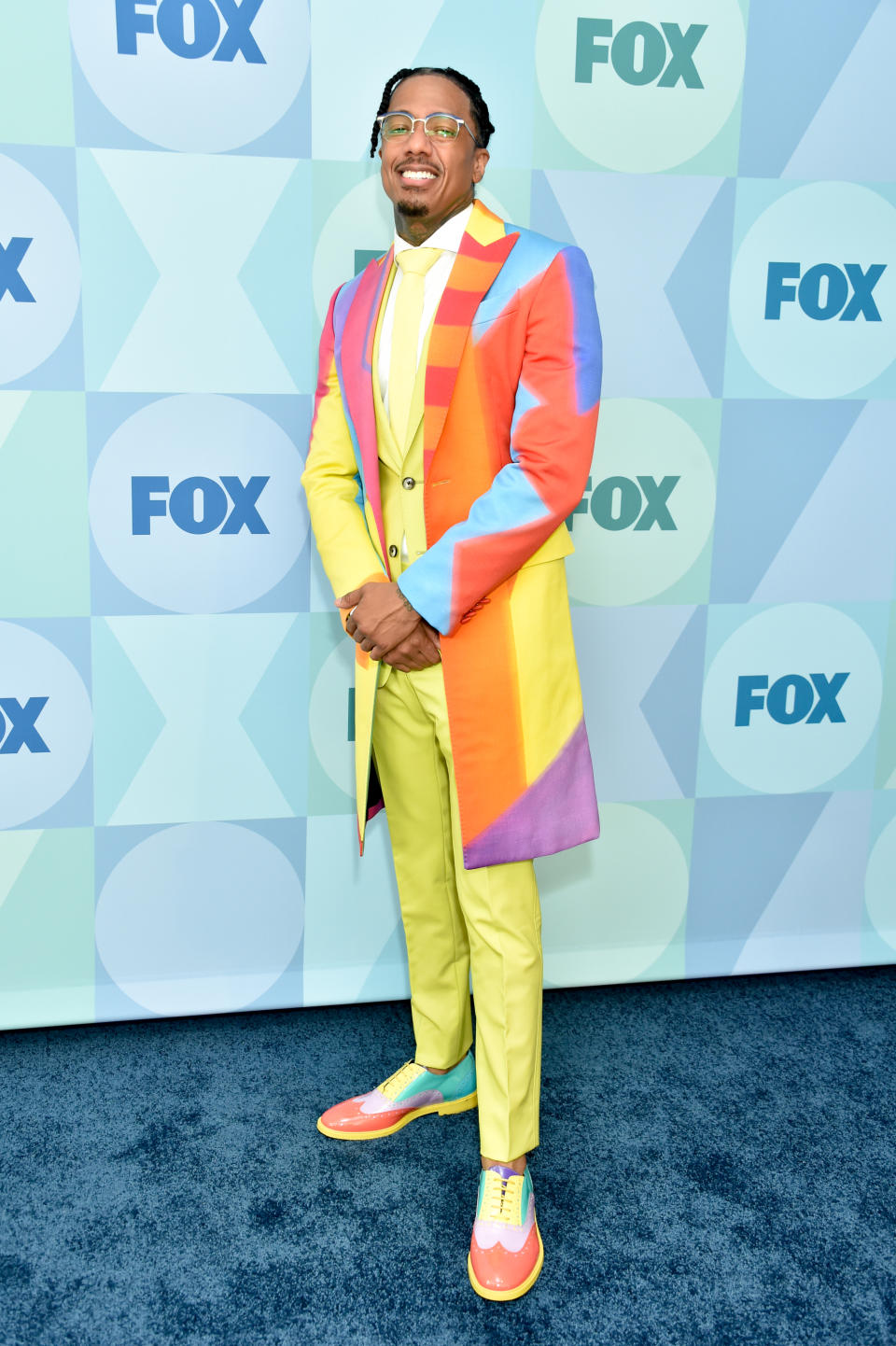Nick Cannon wearing colorful suit