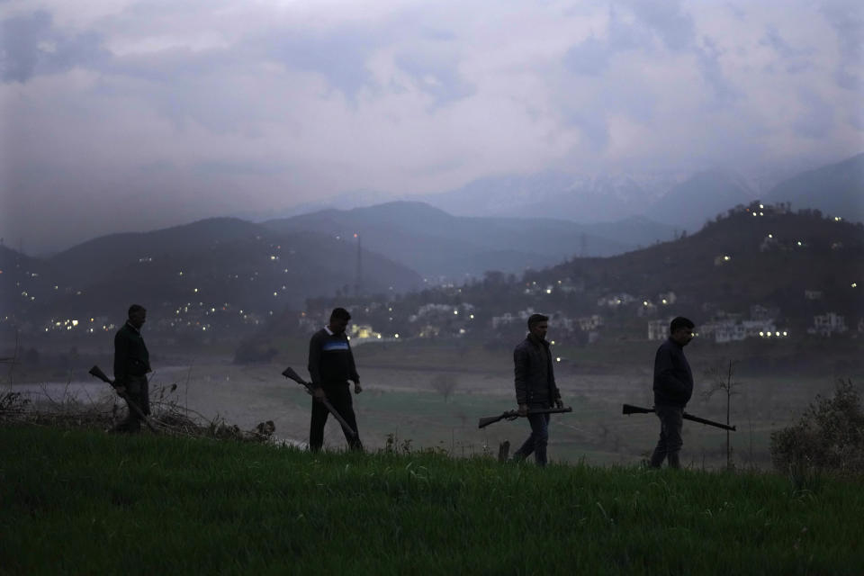 Village Defense Group members patrol during dusk at Muradpur village in Rajouri, India, Feb. 8, 2023. Days after seven Hindus were killed in the village in disputed Kashmir, Indian authorities revived a government-sponsored militia and began rearming and training villagers. The militia, officially called the “Village Defense Group,” was initially formed in the 1990s as the first line of defense against anti-India insurgents in remote villages that government forces could not reach quickly. (AP Photo/Channi Anand)