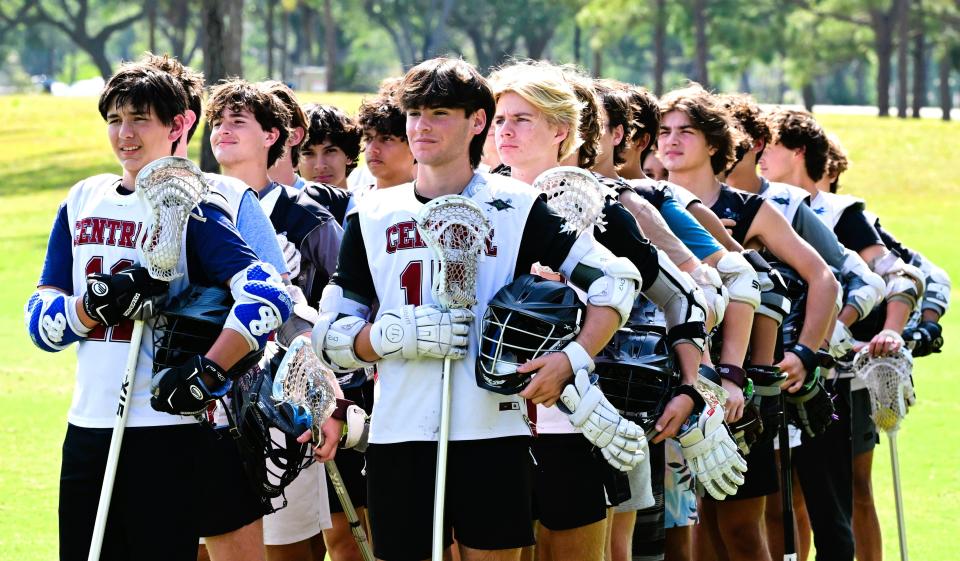 The Palm Beach Central lacrosse team stands in formation, singing the national anthem together during a practice at Okeeheelee on April 4, 2024.