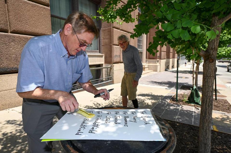 David Clohessy of SNAP, the Survivors Network of those Abused by Priests, wrote the names of priests credibly accused of sexual abuse down Wednesday, June 23, outside the Kansas City-St. Joseph Diocese, 20 W. 9th St., in Kansas City before a sidewalk press conference to denounce that the Diocese has failed to include nearly 20 priests on its list of clergy credibly accused of sex abuse even though they are named elsewhere. Clohessy wrote the names of 18 accused of those priests who worked locally that were left off the accused’ abusers list.