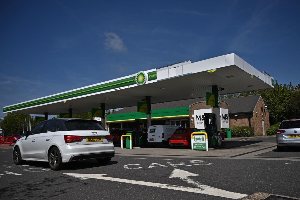 Vehicles fill up at a BP (British Petroleum) petrol station in Tonbridge, south east of London on April 30, 2022. - Britain has been hit hard by rocketing prices of gaz and fuel after the invasion of Ukraine by key gas producer Russia. Britain has vowed to become carbon net zero by 2050, but recently announced plans to drill for more North Sea fossil fuels as it seeks to secure energy independence and axe Russian imports. (Photo by Ben Stansall / AFP) (Photo by BEN STANSALL/AFP via Getty Images)
