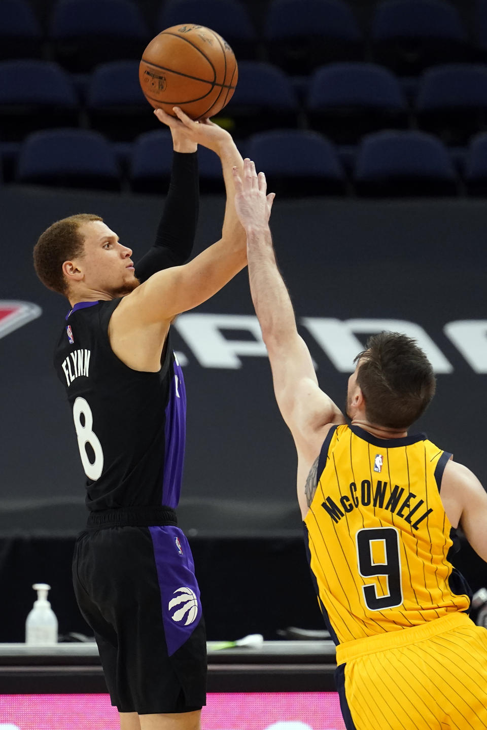 Toronto Raptors guard Malachi Flynn (8) puts up a three-point shot over Indiana Pacers guard T.J. McConnell (9) during the second half of an NBA basketball game Sunday, May 16, 2021, in Tampa, Fla. (AP Photo/Chris O'Meara)