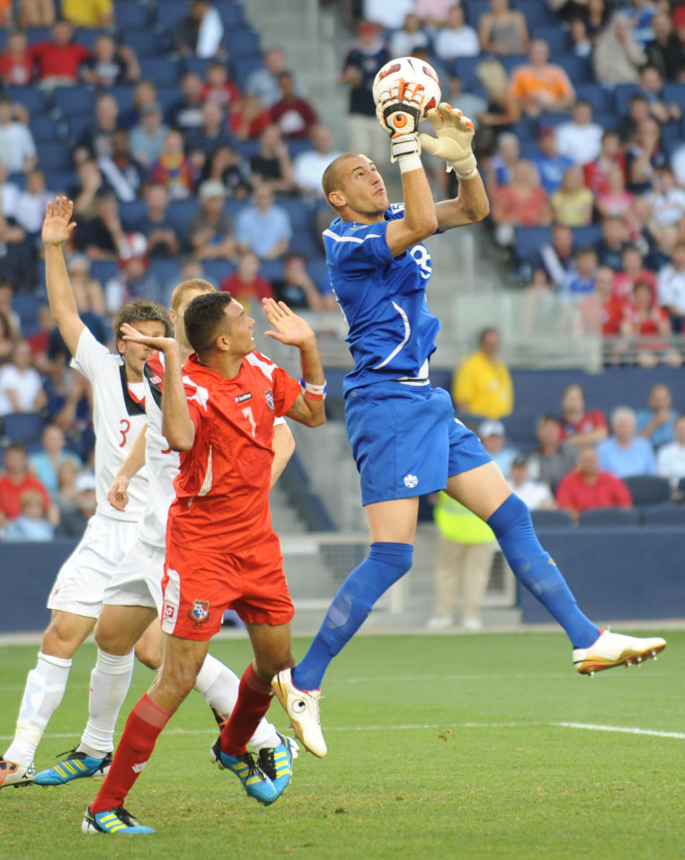 Goalkeeper Milan Borjan of Canada (R) makes a save in front of Blas Perez of Panama (L) during the 2011 CONCACAF Gold Cup Group C match June 14, 2011 at LiveStrong Sporting Park in Kansas City, Kansas. The teams drew, 1-1. AFP PHOTO/Stan HONDA (Photo credit should read STAN HONDA/AFP/Getty Images)