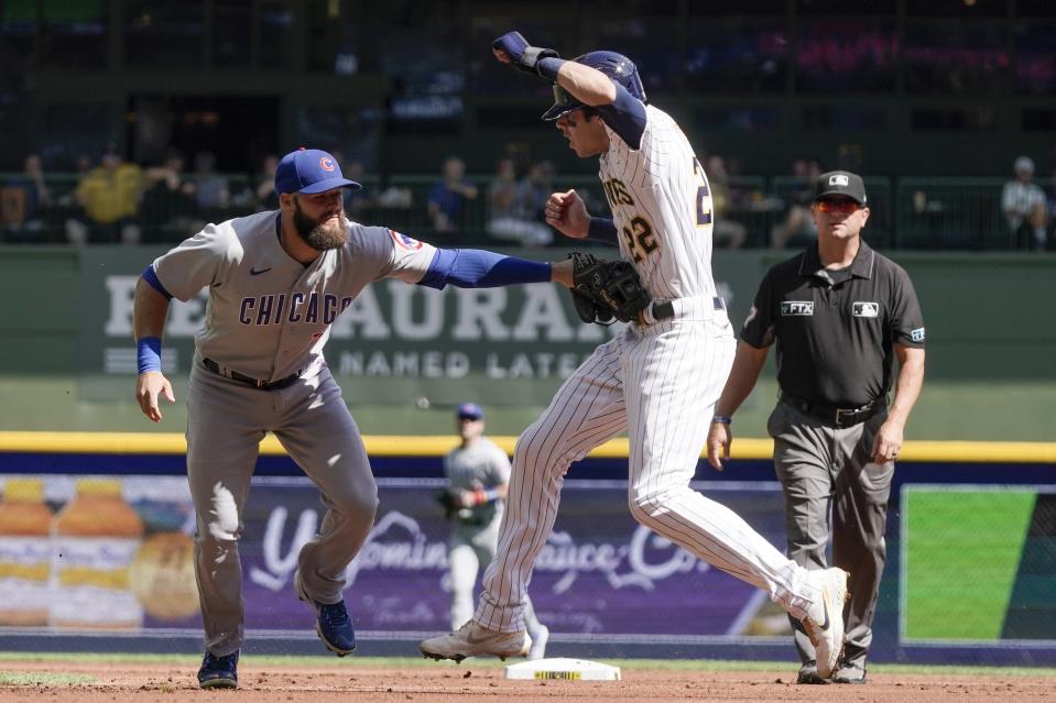 Chicago Cubs' David Bote tags out Milwaukee Brewers' Christian Yelich after being caught in a rundown during the first inning of a baseball game Sunday, Sept. 19, 2021, in Milwaukee. (AP Photo/Morry Gash)