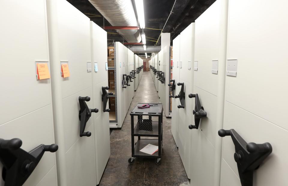 A cart rests in an aisle between storage racks at the Muskingum County Records Center in Zanesville.