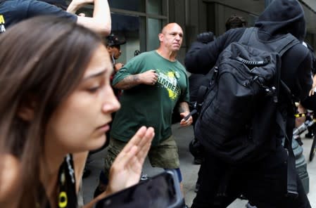 A supporter of the Proud Boys, center, fights with counter-protesters after a Proud Boys rally in Portland, Oregon