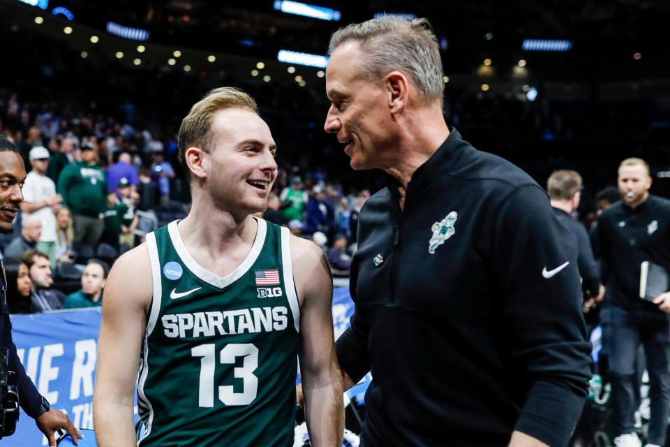 Michigan State guard Steven Izzo (13) celebrates 69-51 win over Mississippi State with assistant coach Doug Wojcik at NCAA tournament West Region first round at Spectrum Center in Charlotte, N.C. on Thursday, March 21, 2024.