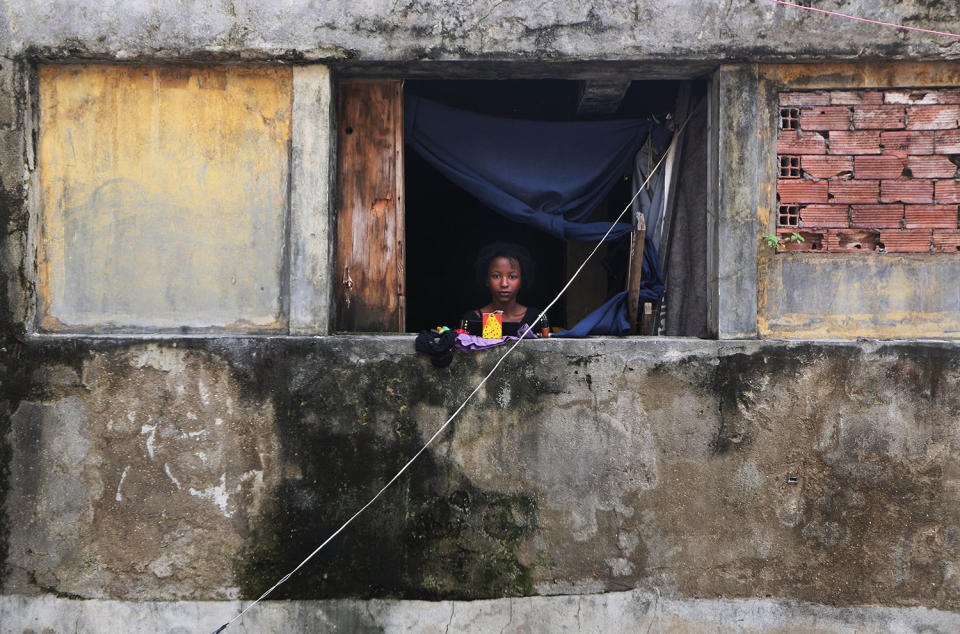 Girl standing in window of home