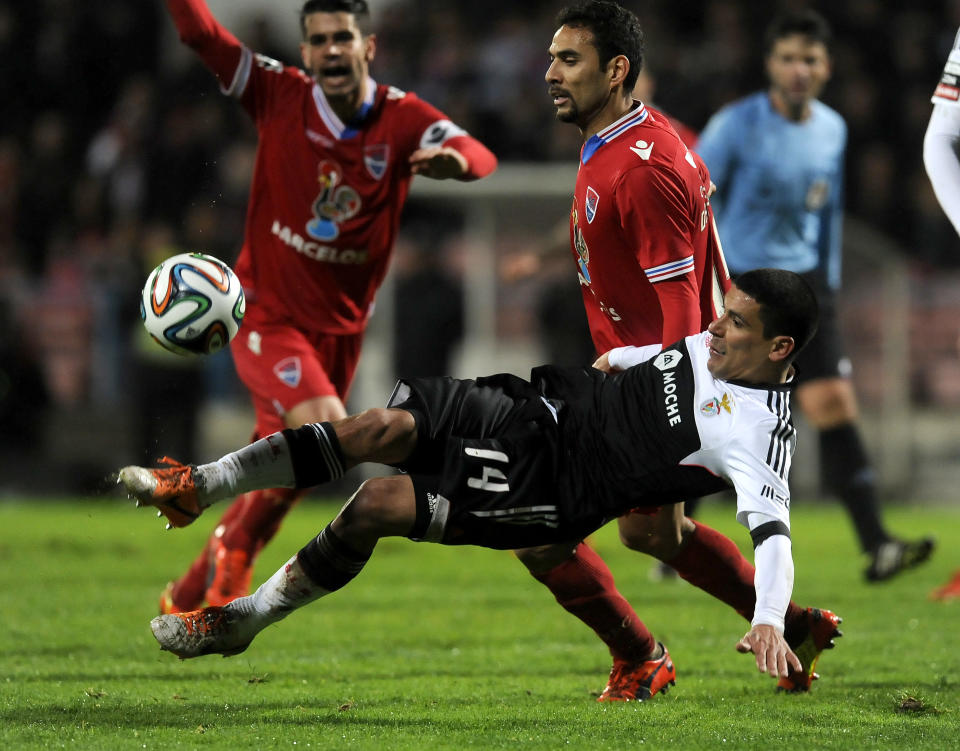 Benfica's Maxi Pereira, front, from Uruguay attempts a shot past by Gil Vicente's Danielson Trindade, from Brazil, in a Portuguese League soccer match at the Cidade de Barcelos stadium, in Barcelos, northern Portugal, Saturday, Feb. 1, 2014. The match ended in a 1-1 draw. (AP Photo/Paulo Duarte)