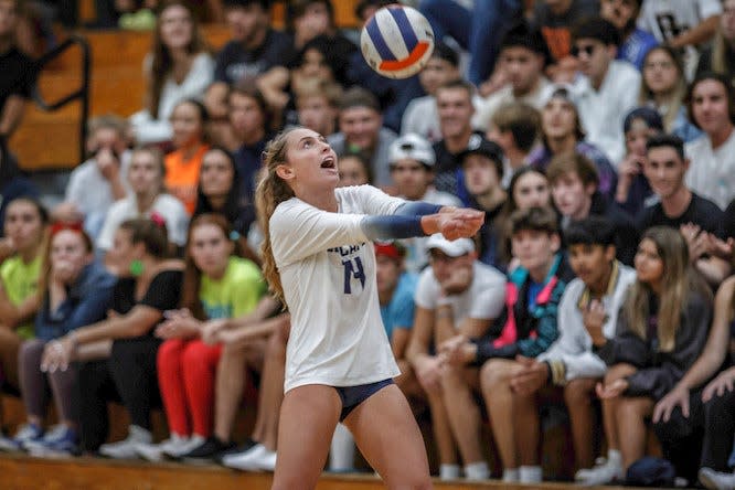 Heather McKenzie (14) digs the ball as the Boca Raton Community High School Bobcats hosted the West Boca Raton Community High School Bulls in Florida High School Athletic Association Class 7A regional semifinal girl's volleyball action in Boca Raton, Fla, on Wednesday, November 3, 2021. The Bobcats bested the Bulls in five games; 25-17, 24-26, 18-25, 26-24, 15-10. 