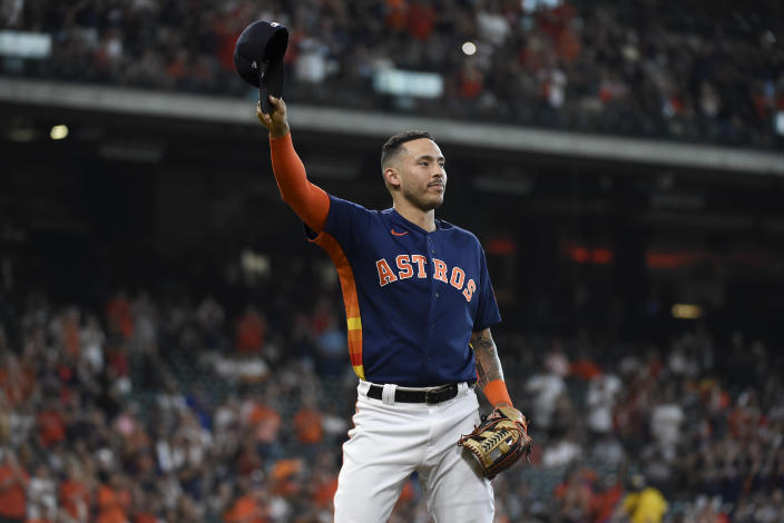 Houston Astros' Carlos Correa acknowledges the crowd after being pulled from baseball game before the ninth inning against the Oakland Athletics, Sunday, Oct. 3, 2021, in Houston. (AP Photo/Eric Christian Smith)
