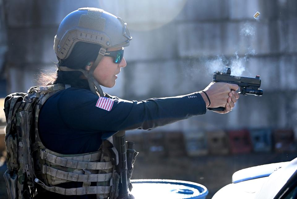 Former Congresswoman Tulsi Gabbard fires a pistol at targets during the 2021 Tactical Challenge at the U.S. Army John F. Kennedy Special Warfare Center and School's Miller Training Complex on Dec. 16, 2021. Twelve celebrities teamed up with Green Berets to take part in the annual event.