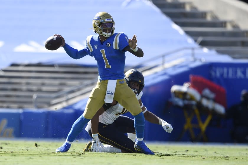 UCLA quarterback Dorian Thompson-Robinson, front, throws a pass in front of California linebacker Cameron Goode.