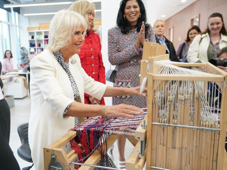 Queen Camilla tries her hand at weaving (PA)