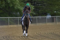 Exercise rider Oscar Quevedo rides atop Preakness entrant Secret Oath during a morning workout ahead of the Preakness Horse Race at Pimlico Race Course, Wednesday, May 18, 2022, in Baltimore. Trainer D. Wayne Lukas believes Secret Oath could be one of the best fillies he has ever had. That belief and her winning the Kentucky Oaks in impressive fashion the day before the Derby inspired him to enter Secret Oath in the Preakness Stakes, where she could give the 86-year-old Hall of Fame trainer a record-tying seventh victory in the second jewel of the Triple Crown. (AP Photo/Julio Cortez)