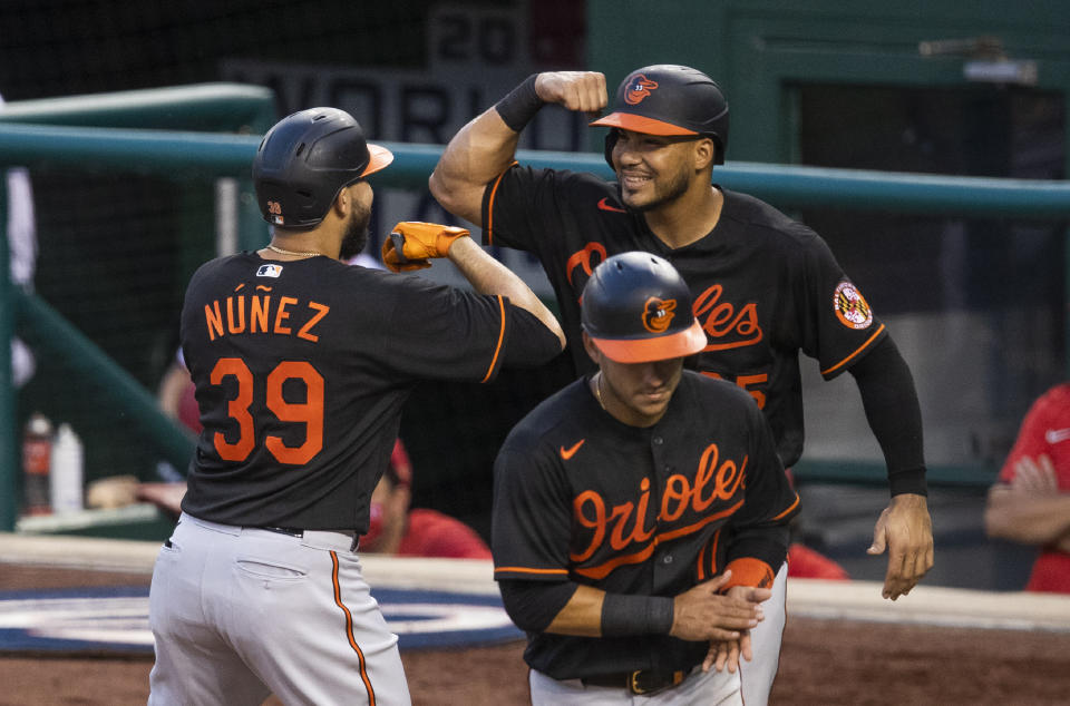 Baltimore Orioles' Renato Nunez (39) celebrates with teammate Anthony Santander (25) after hitting a three-run home run during the sixth inning of a baseball game against the Washington Nationals in Washington, Friday, Aug. 7, 2020. (AP Photo/Manuel Balce Ceneta)