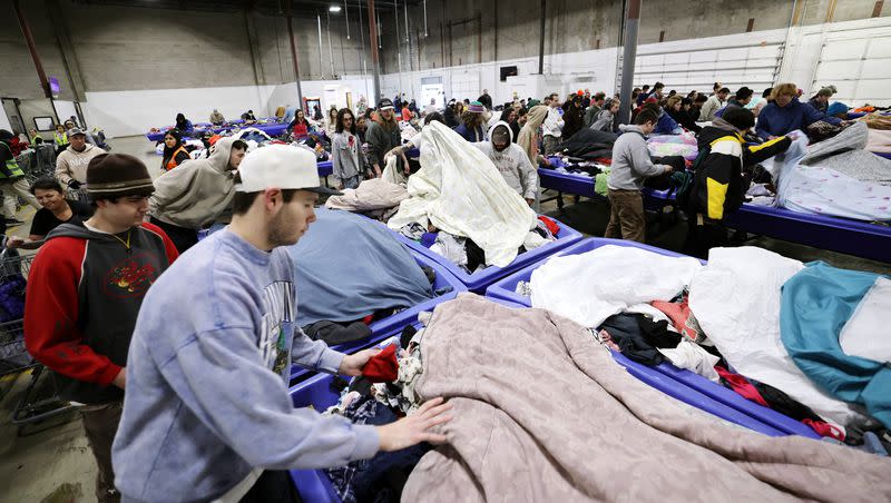 Customers rush in and uncover the new products at the Goodwill Outlet in Salt Lake City on Monday, March 6, 2023.