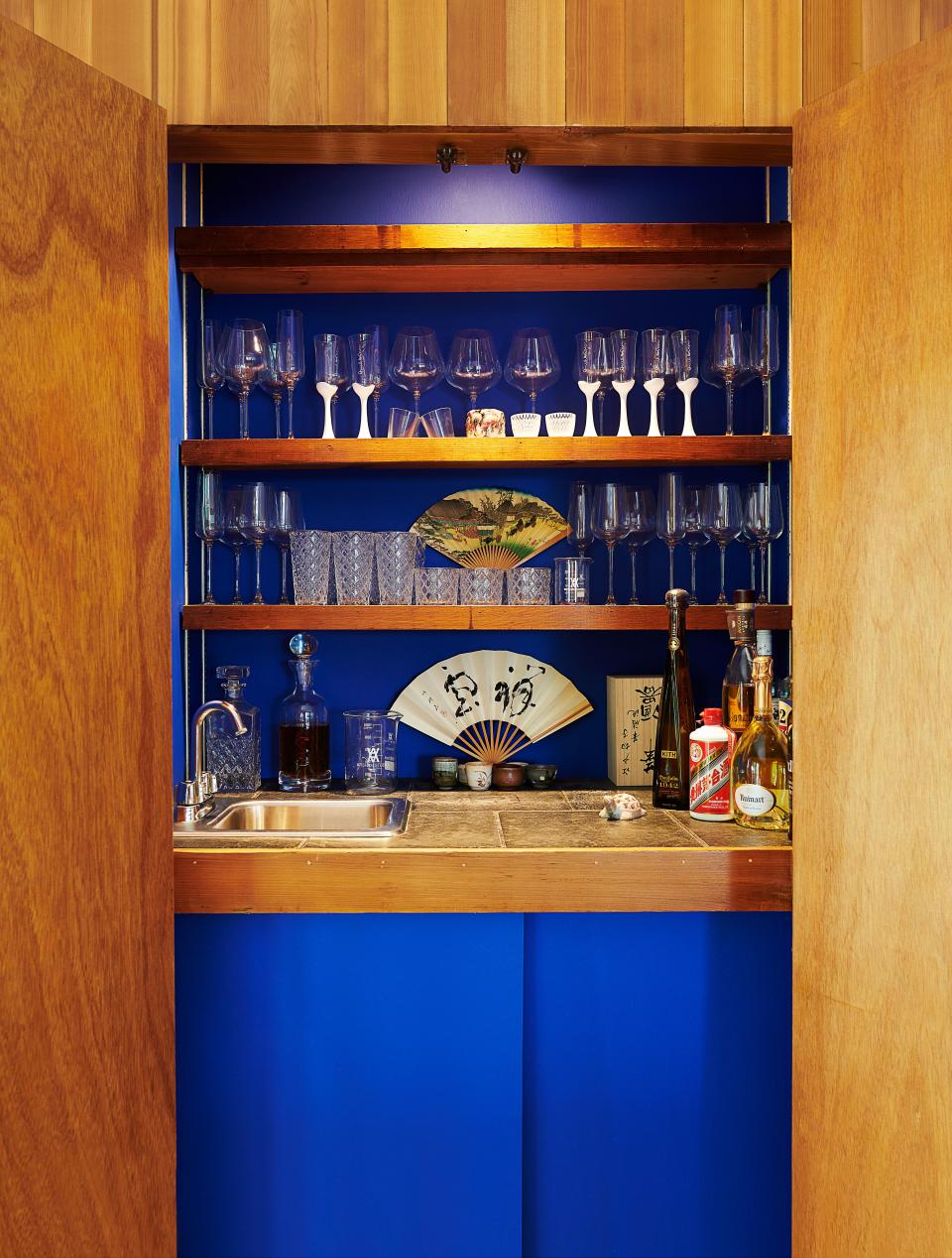 Vintage sake glasses and Japanese fans join Arsham's own designs in the wet bar.