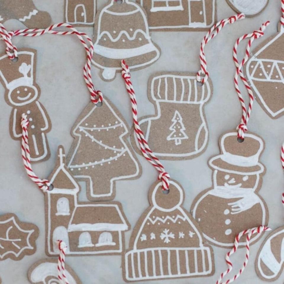 Cardboard gift tags in holiday shapes like Christmas trees, churches, hats, and snowmen.