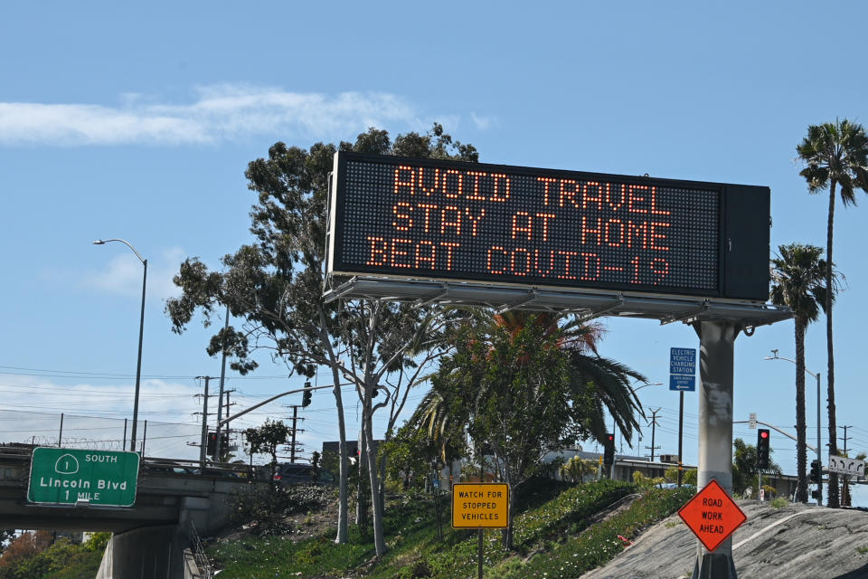 Highway digital signs display messages about stay home and avoiding travel during an outbreak of the COVID-19 coronavirus, Los Angeles, California, March 25, 2020.