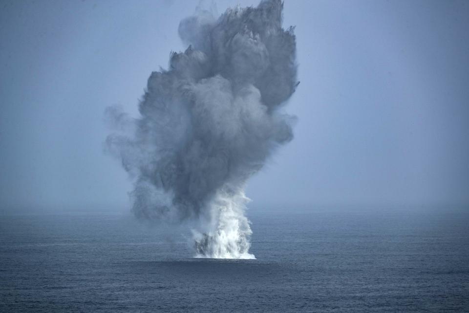 In this Thursday, July 4, 2019, photo made available by U.S. Navy, two F/A-18 Super Hornets assigned to Carrier Air Wing (CVW 7) drop 1000-pound general-purpose bombs during an Independence Day air power demonstration next to the Nimitz-class aircraft carrier USS Abraham Lincoln in Arabian Sea. The USS Abraham Lincoln was rushed to the Mideast amid tensions between the U.S. and Iran as its 2015 nuclear deal with world powers unravels. (Mass Communication Specialist 3rd Class Jeff Sherman/U.S. Navy via AP)