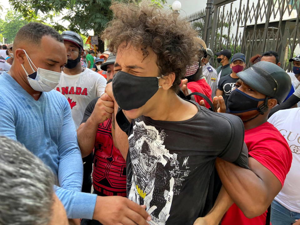 Plain clothes police officers detain a person during protests against and in support of the government, amidst the coronavirus disease (COVID-19) outbreak, outside the Capitol building, in Havana, Cuba July 11, 2021. REUTERS/Stringer