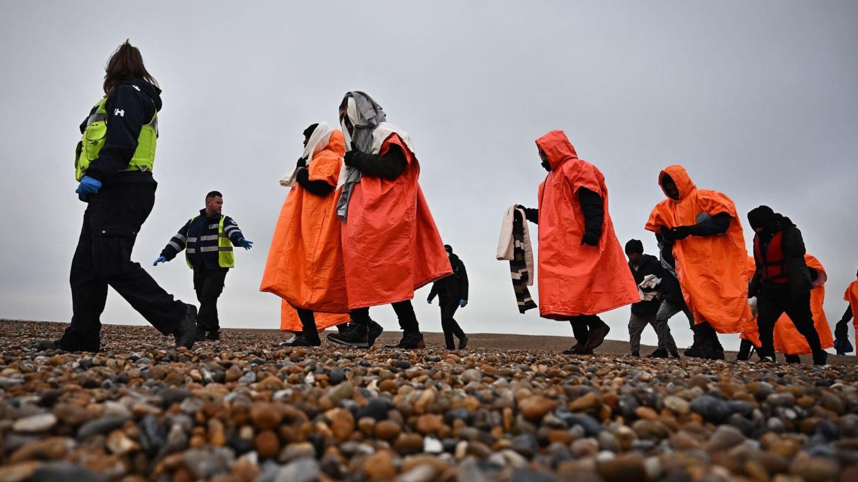  Migrants escorted by British immigration enforcement officers. 