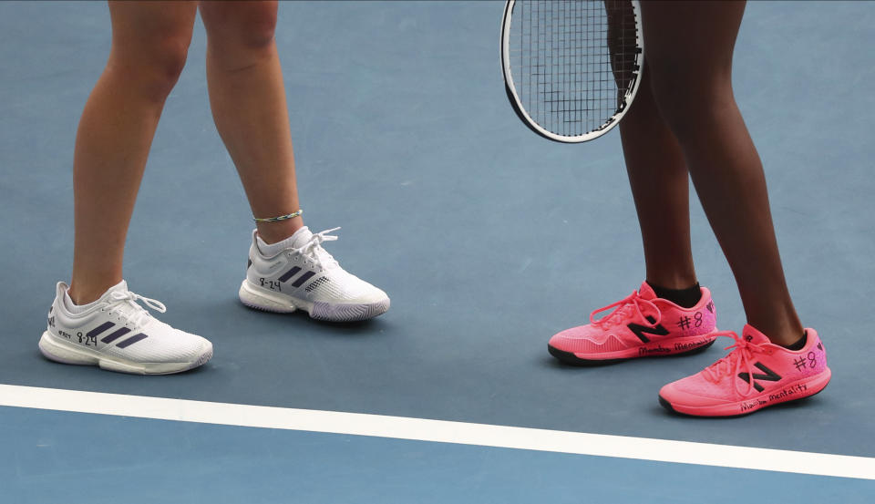 United States' Coco Gauff, right, and compatriot Caty McNally wear a tribute to Kobe Bryant on their shoes during their doubles match against Japan's Shuko Aoyama amd Ena Shibahara at the Australian Open tennis championship in Melbourne, Australia, Monday, Jan. 27, 2020. (AP Photo/Dita Alangkara)