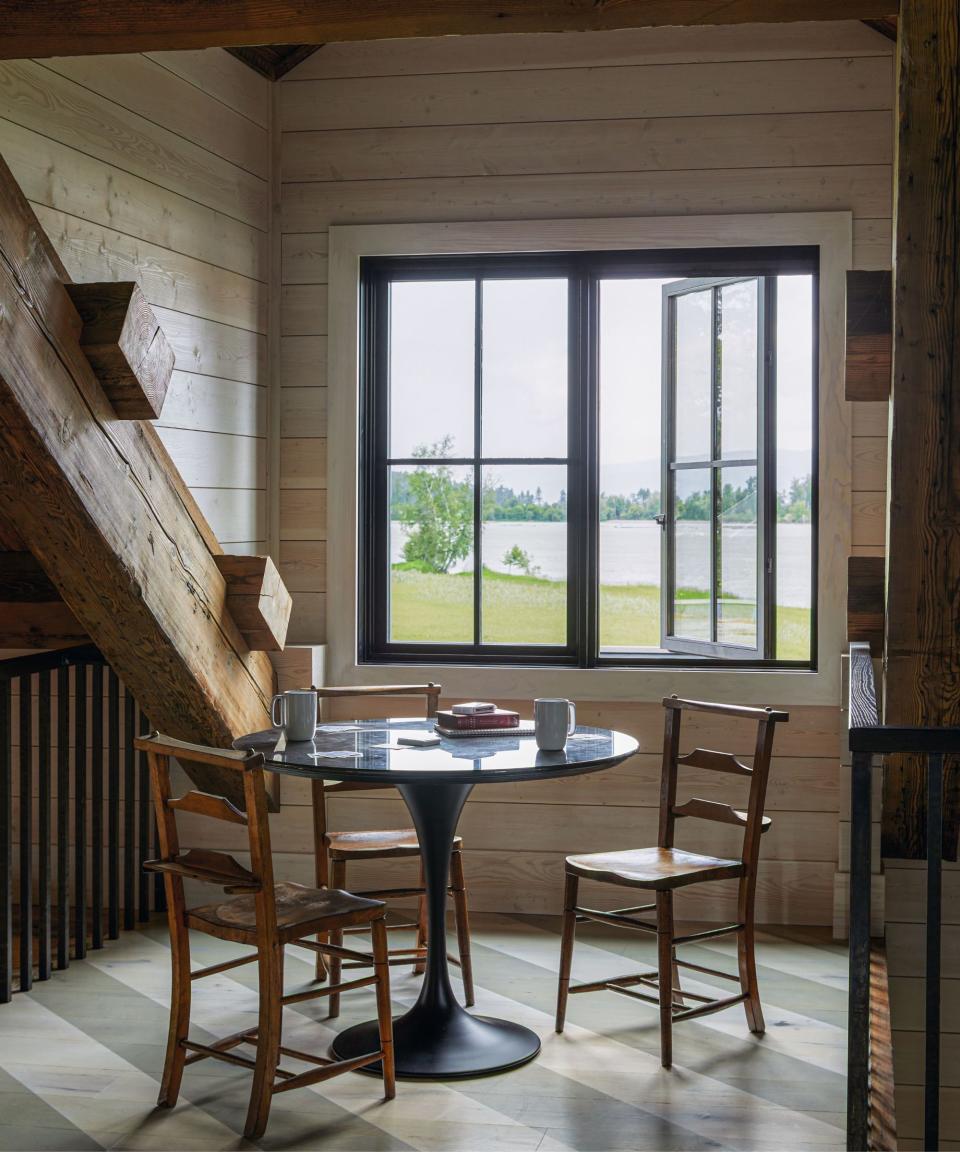 Black table, wooden chairs, black railing