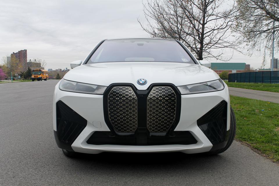 The front grille area of a white BMW iX electric SUV.