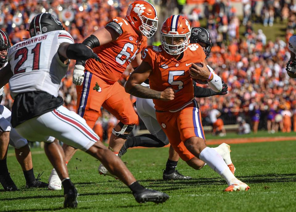 Clemson quarterback D.J. Uiagalelei (5) runs by South Carolina defensive back Nick Emmanwori (21) for a touchdown during the first quarter at Memorial Stadium in Clemson, South Carolina Saturday, Nov. 26, 2022.   