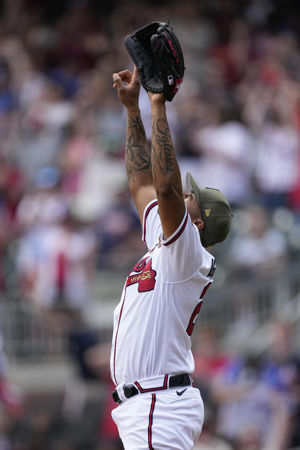 Atlanta Braves relief pitcher Raisel Iglesias (26) reacts after recording the final out in the ninth inning of a baseball game against the Seattle Mariners, Sunday, May 21, 2023, in Atlanta. Iglesias earned a save. (AP Photo/John Bazemore)