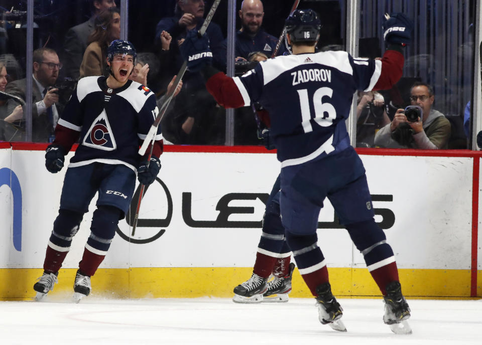 Colorado Avalanche center Tyson Jost, back, celebrates scoring a goal with defenseman Nikita Zadorov in the second period of an NHL hockey game against the St. Louis Blues Saturday, Jan. 18, 2020, in Denver. (AP Photo/David Zalubowski)