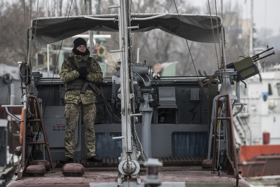 A Ukrainian serviceman stands on board a coast guard ship in the Sea of Azov port of Mariupol, eastern Ukraine, Monday, Dec. 3, 2018. The Ukrainian military has been on increased readiness as part of martial law introduced in the country in the wake of the Nov. 25, 2018 incident in the Sea of Azov, in which the Russian coast guard fired upon and seized three Ukrainian navy vessels along with their crews. (AP Photo/Evgeniy Maloletka)