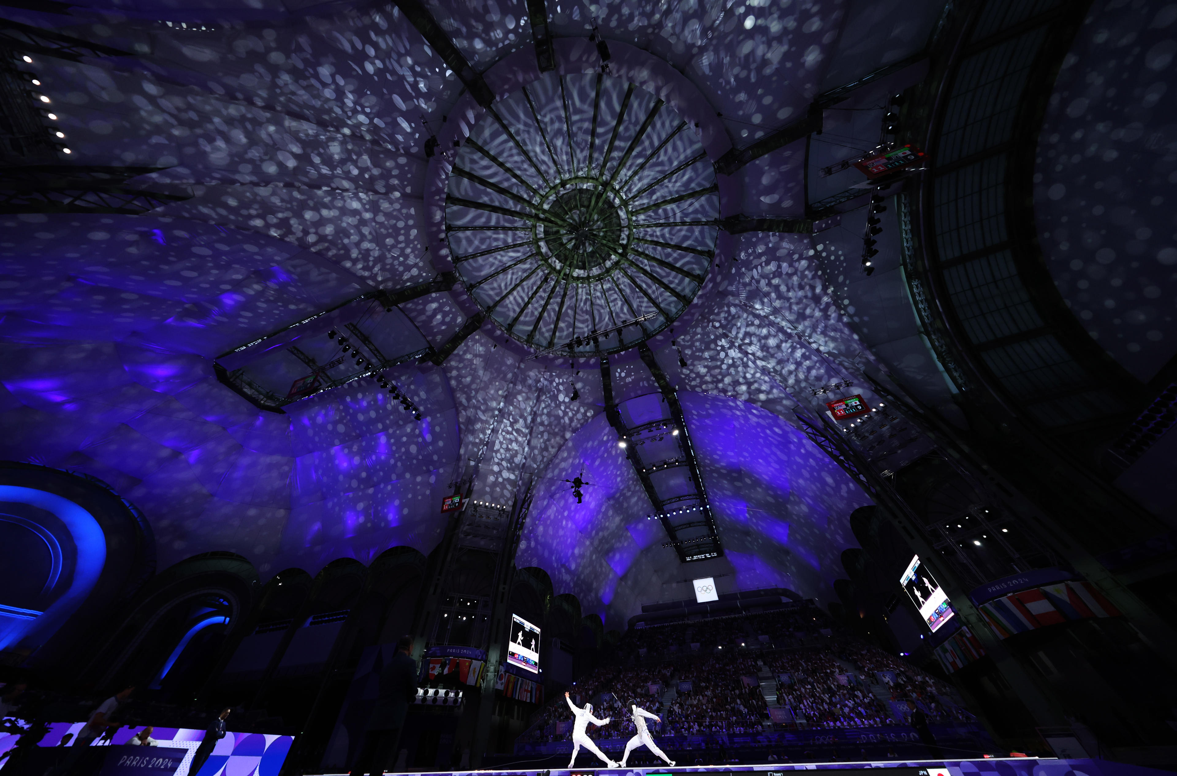 Kazuki Iimura of Japan (R) and Nick Itkin of United States compete in the fencing men's foil bronze medal match at the Grand Palais at the Paris Olympics. (Al Bello/Getty Images)