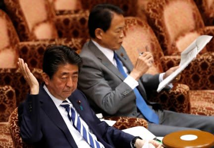 Japan's Prime Minister Shinzo Abe and Finance Minister Taro Aso atttend at an upper house parliamentary session in Tokyo, Japan March 19, 2018.  REUTERS/Issei Kato