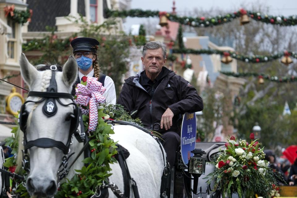 Utah head coach Kyle Whittingham, right, sits on a carriage in a parade for the Rose Bowl Team Visit Disneyland Resort in Anaheim, Calif., Monday, Dec. 27, 2021. | Ringo H.W. Chiu, Associated Press
