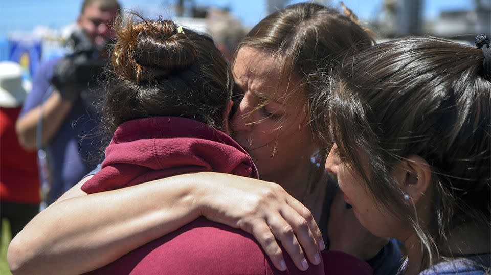 A relative of one of the 44 crew members of Argentine missing submarine, is comforted outside Argentina's Navy base in Mar del Plata. Source: Getty