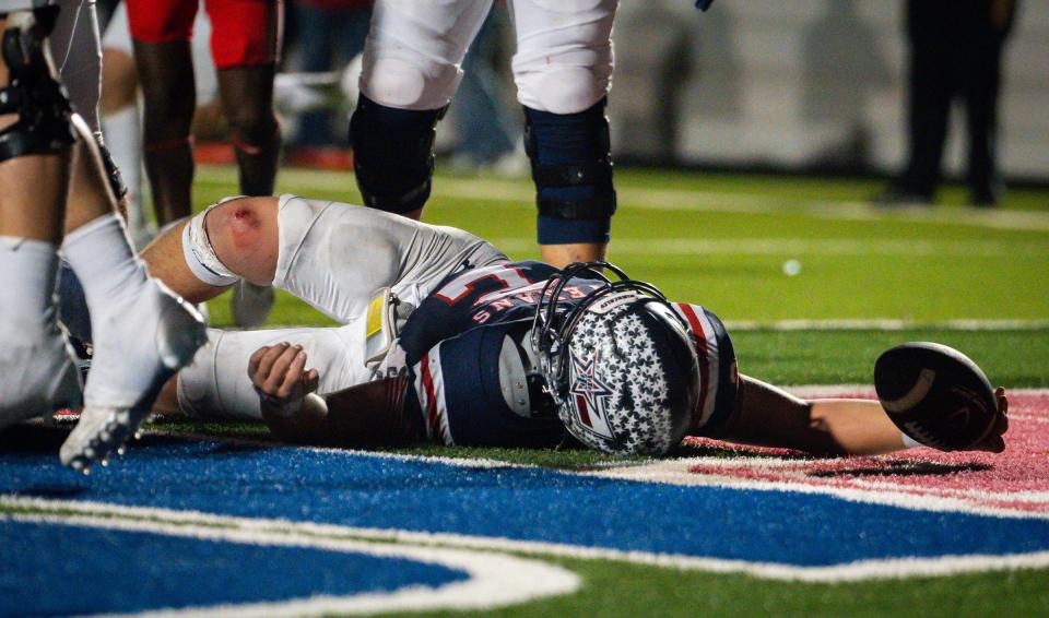 Wimberley's Cody Stoever sprawls on the ground after scoring his fifth touchdown in the final minute of Friday's loss to Bellville. His try for a 2-point conversion fell an inch short, though, and the Brahmas ran out the clock.