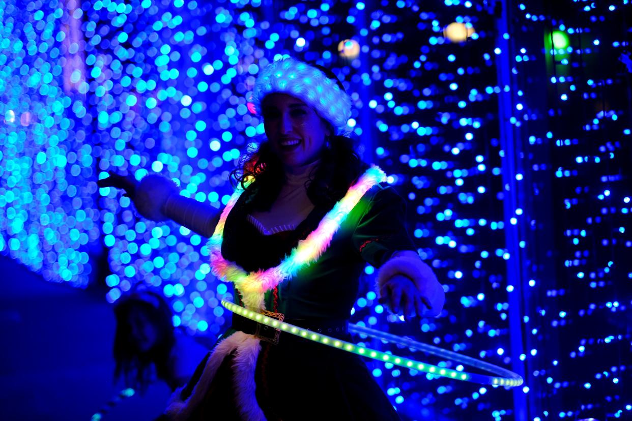 Alexis Thompson with Inspyral Circus, entertains with hula hoops at Lights on Broadway in Automobile Alley, part of Downtown in December, Saturday, December 4, 2021.