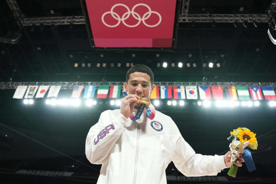 Devin Booker, left, is part of an elite group of Kentucky men’s basketball alums who have won a gold medal at an Olympics while representing the United States.