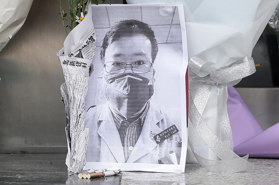 A photo of the late ophthalmologist Li Wenliang is seen with flower bouquets at the Houhu Branch of Wuhan Central Hospital in Wuhan in China's central Hubei province on February 7, 2020. - A Chinese doctor who was punished after raising the alarm about China's new coronavirus died from the pathogen on February 7, sparking an outpouring of grief and anger over a worsening crisis that has now killed more than 630 people. (Photo by STR / AFP) / China OUT (Photo by STR/AFP via Getty Images)