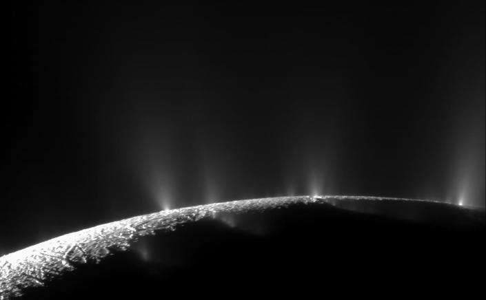 dark moon enceladus horizon with white jets shooting into space