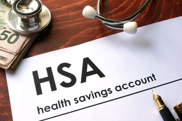 Word HSA written on a paper near wad of bills