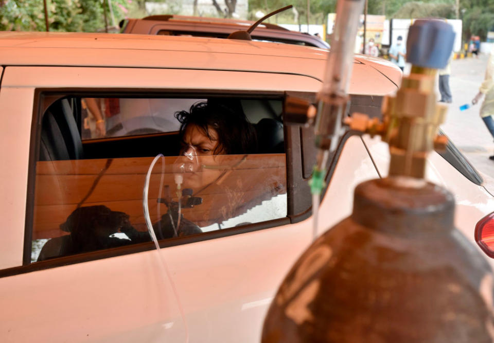 A Covid-19 patient receiving oxygen support in a car at an "Oxygen langar" by Gurdwara Damdama Sahib, on May 2, 2021 in New Delhi, India.<span class="copyright">Sanjeev Verma/Hindustan Times via Getty Images</span>