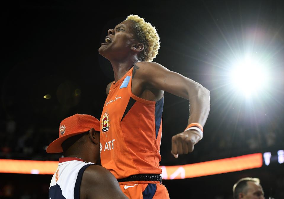 Connecticut Sun's Courtney Williams gets a lift from her father Don Williams after the Sun defeated the Washington Mystics in Game 4 of basketball's WNBA Finals, Tuesday, Oct. 8, 2019, in Uncasville, Conn. (AP Photo/Jessica Hill)