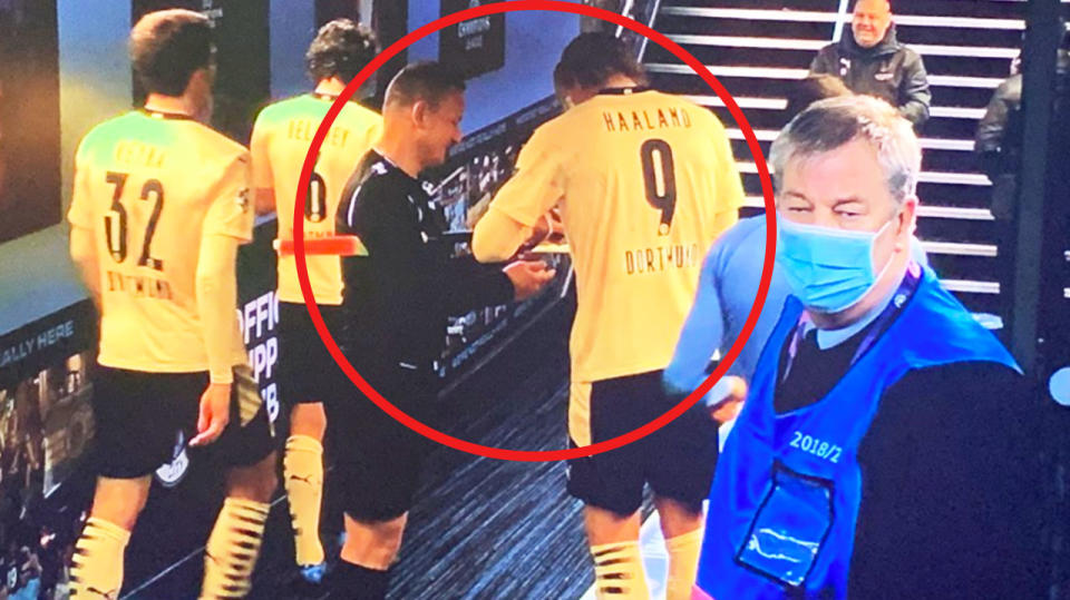 Erling Haaland (pictured middle right) appearing to sign an object for assistant referee Octavian Sovre (pictured middle left).