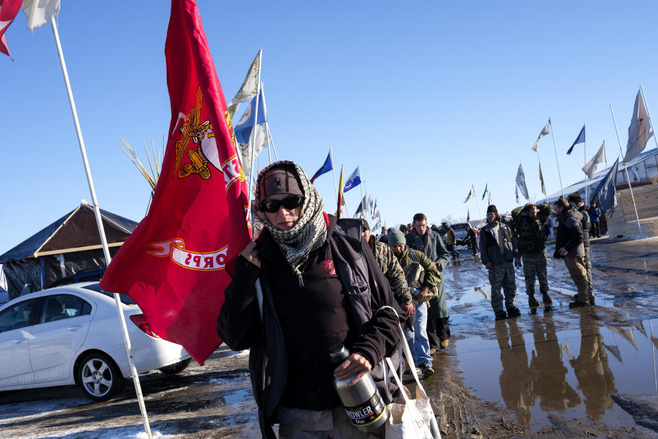 Lita Boyd, a veteran of the U.S. Army, leads a group of veterans to the checkin area at the Oceti Sakowin campground north of Cannon Ball, N.D.