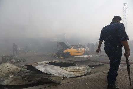 Smoke rises at the site of a car bomb attack in Baghdad al-Jadida, Iraq April 25, 2016. REUTERS/Ahmed Saad