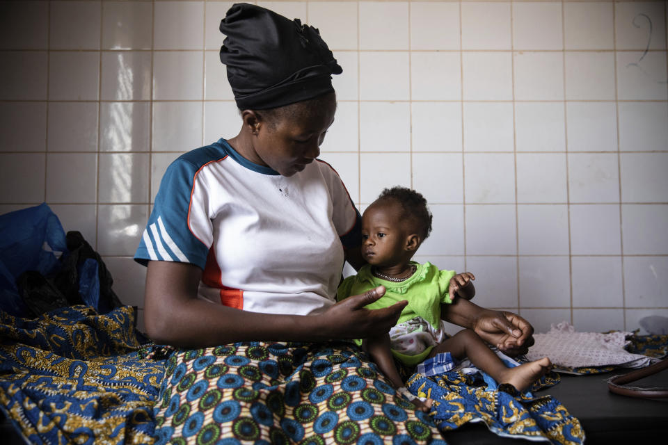 A woman and her 10-month-old daughter sit in a hospital room.